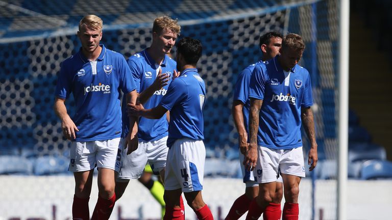 Michael Smith (2nd L) of Portsmouth FC celebrates scoring a goal against Bournemouth during a pre-season friendly