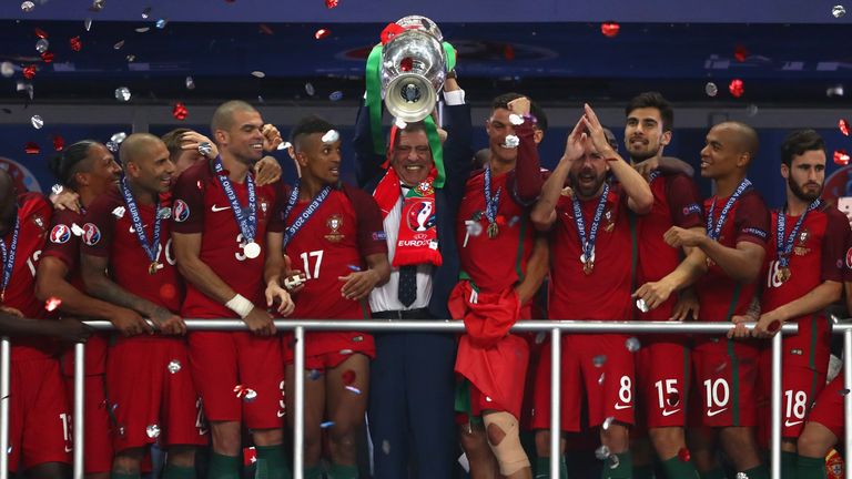 Fernando Santos manager of Portugal (c) lifts the Henri Delaunay trophy after his side win 1-0 against France during the UEFA EUR