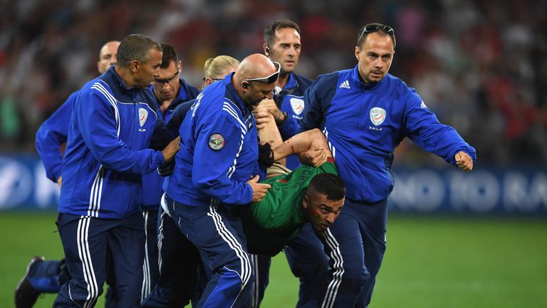MARSEILLE, FRANCE - JUNE 30:  An invading fan is taken by stewards off the pitch during the UEFA EURO 2016 quarter final match between Poland and Portugal 