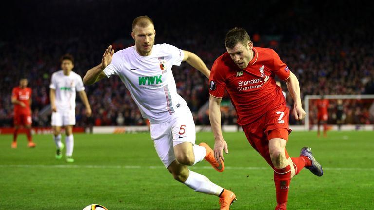 LIVERPOOL, ENGLAND - FEBRUARY 25:  James Milner of Liverpool and Ragnar Klavan of Augsburg compete for the ball during the UEFA Europa League Round of 32 s