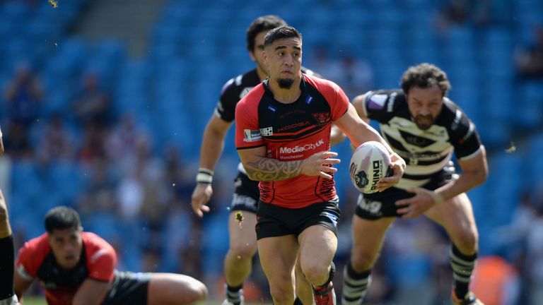 MANCHESTER, ENGLAND - MAY 17:  Rangi Chase of Salford Red Devils breaks through the tackles of Jon Clarke and Magraff Leuluai of Widnes Vikings to score hi