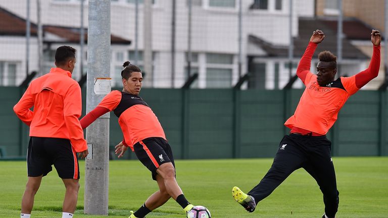 Mario Balotelli - back at Liverpool after an unsuccessful loan spell with AC Milan - gets stuck in with Roberto Firmino