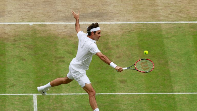 Roger Federer plays a backhand