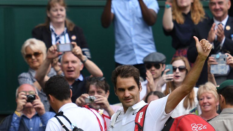 Switzerland's Roger Federer waves to the crowd after losing to Canada's Milos Raonic 