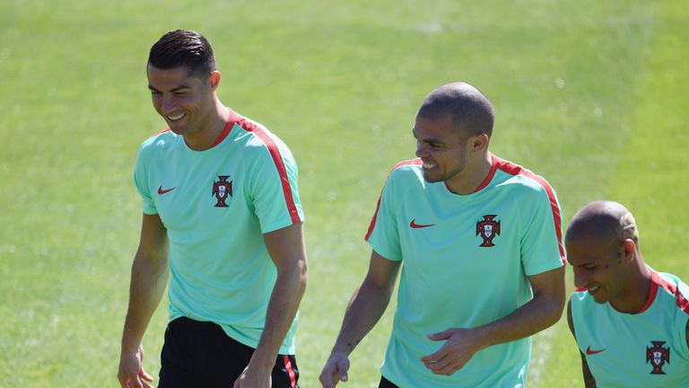Cristiano Ronaldo and Pepe of Portugal share a joke during a Portugal training session, ahead of the UEFA Euro 2016 Final v France