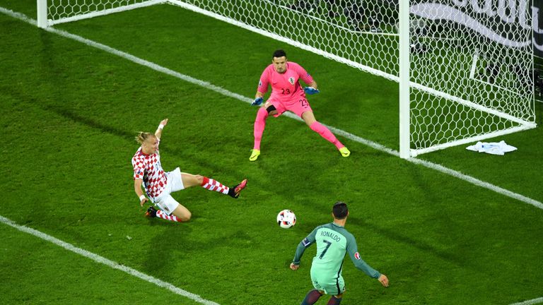 LENS, FRANCE - JUNE 25:  Cristiano Ronaldo (R) of Portugal shoots at goal saved by Danijel Subasic (C) of Croatia setting up the first goal by Ricardo Quar