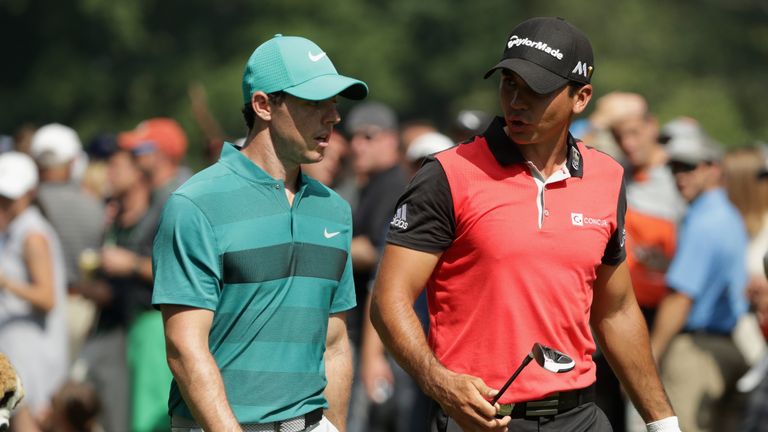 (L-R) Rory McIlroy of Northern Ireland and Jason Day of Australia walk off the fifth tee during the second round of the 2016 PGA