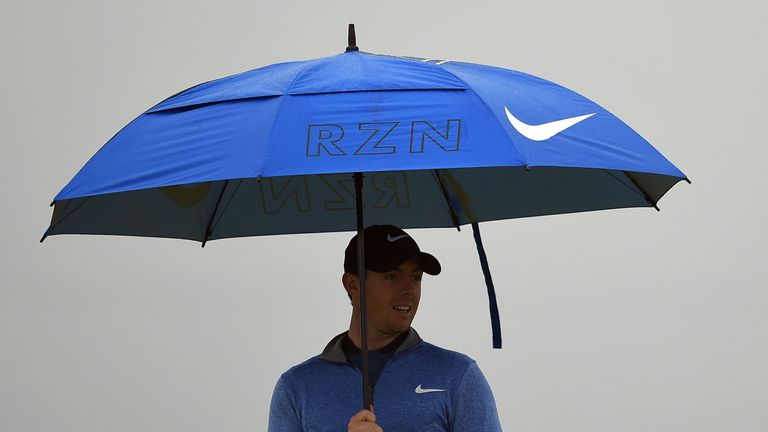 Northern Ireland's Rory McIlroy shelters from the rain under an umbrella during his second round on day two of the 2016 British Open Golf Championship at R