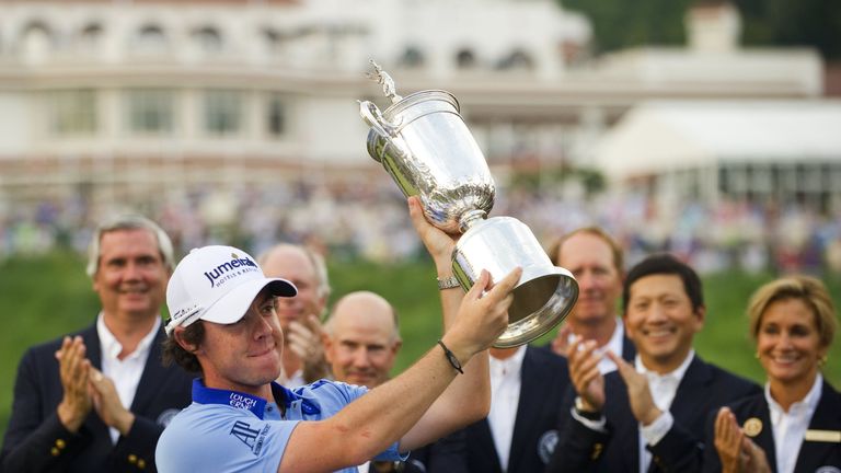 Rory McIlroy of Northern Ireland holds up the trophy after winning the 111th US Open