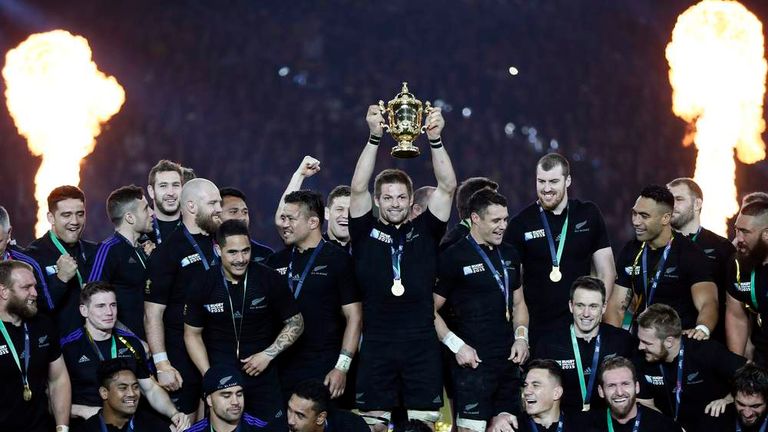 New Zealand's team celebrates with the Webb Ellis trophy after winning the Rugby World Cup Final against Australia at Twickenham in London