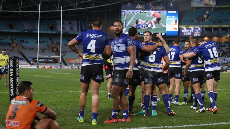 Canterbury Bulldogs players celebrate a try against Wests Tigers