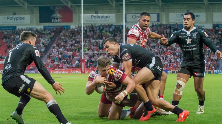 Hull FC's Fetuli Talanoa is unable to prevent Wigan's George Williams from scoring a try
