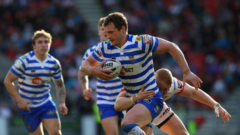Wigan captain Sean O'Loughlin runs with the ball against St Helens