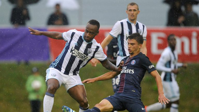 Saido Berahino of West Bromwich Albion (L) fights for ball with Lorenzo Callegari of Paris Saint-Germain during their friendly football match in Schladming