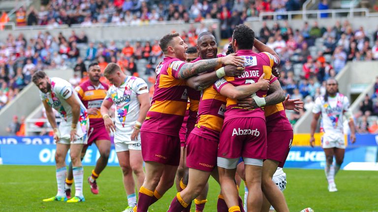 Huddersfield's Sam Rapira is congratulated on his try by team-mates.