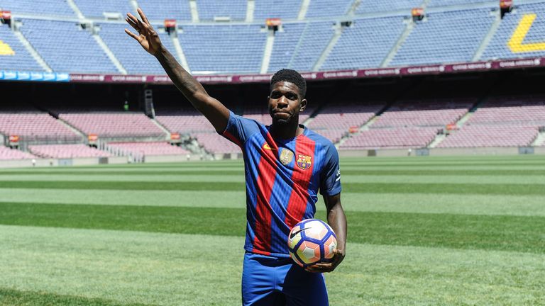 Samuel Umtiti waves to Barcelona supporters during his official presentation at the Camp Nou 