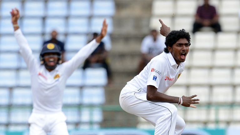 Sri Lanka's Lakshan Sandakan (R) appeals during the fifth and the final day of their opening Test match between Sri Lanka and Australia at the Pallekele In