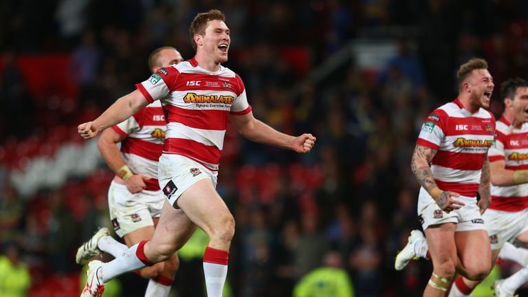 MANCHESTER, ENGLAND - OCTOBER 05: Scott Taylor (L) of Wigan Warriors celebrates at the final whistle after his sides 30-16 victory during the Super League 