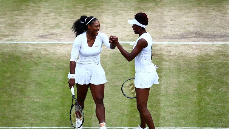 LONDON, ENGLAND - JULY 08:  Serena Williams of The United States and Venus Williams of The United States celebrates victory during the Ladies Doubles first