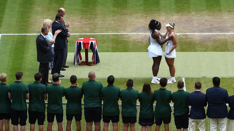 US player Serena Williams (top 2R) with the winner's trophy, the Venus Rosewater Dish, greets runner up Germany's Angelique Kerber (top R) during the prese