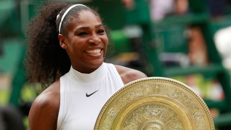 Serena Williams celebrates with the Wimbledon trophy