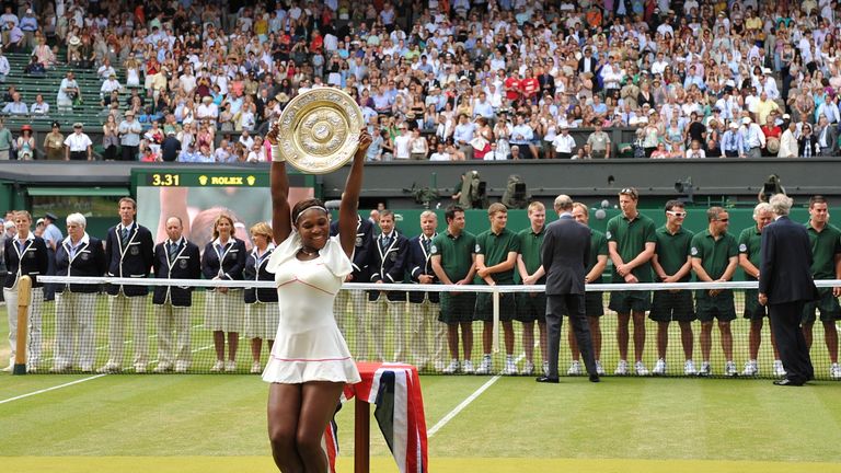 Serena Williams of US holds the Wimbledon Trophy after defeating Vera Zvonareva of Russia in the Women's Final at the Wimbledon Tennis Championships at the