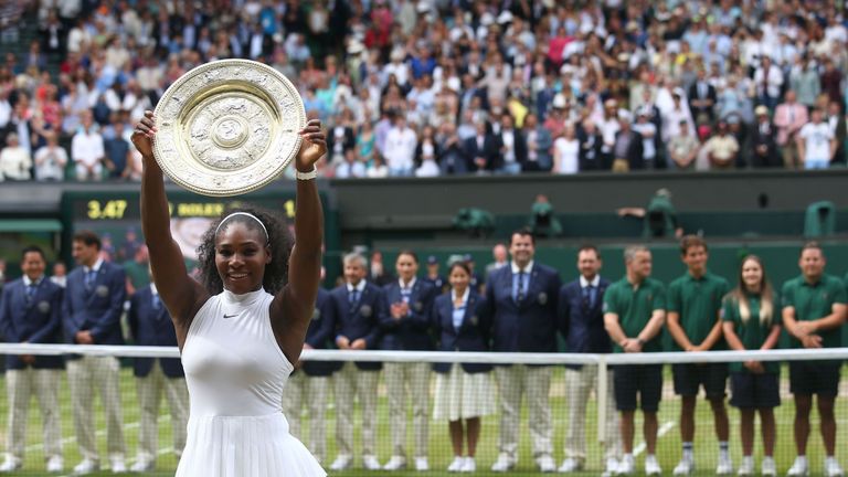 US player Serena Williams poses with the winner's trophy, the Venus Rosewater Dish, after her women's singles final victory over Germany's Angelique Kerber