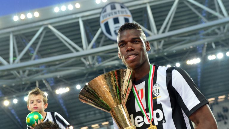 Juventus' French midfielder Paul Pogba celebrates with the trophy during the ceremony of the Scudetto, the Italian Serie A trophy