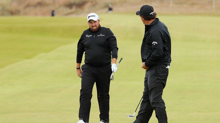 INVERNESS, SCOTLAND - JULY 07:  Shane Lowry of Ireland is congratulated by Phil Mickelson on the 13th hole after chipping in for a birdie during the first 