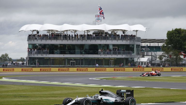 Mercedes AMG Petronas F1 Team's German driver Nico Rosberg (L) drives during a practice session at Silverstone motor racing circuit in Silverstone, central