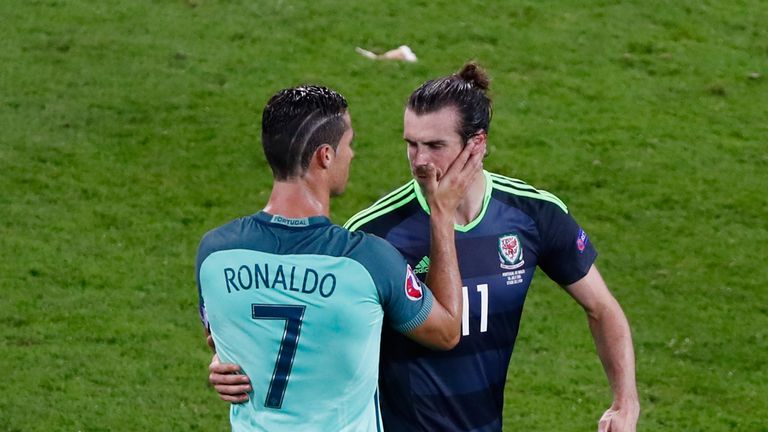Real Madrid team-mates Gareth Bale of Wales and Cristiano Ronaldo of Portugal embrace after their Euro 2016 semi-final which Portugal won 2-0