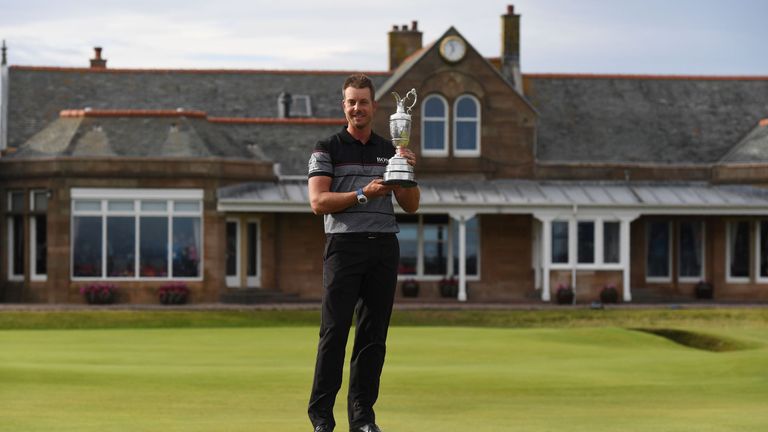 Sweden's Henrik Stenson poses for pictures in front of the clubhouse with the Claret Jug, the trophy for the Champion golfer of the year after winning the 