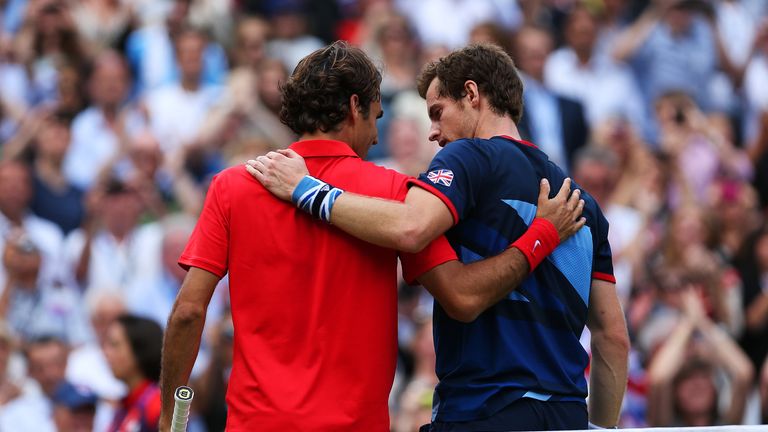 Andy Murray speaks with Roger Federer at the net after the Men's Singles Tennis Gold Medal