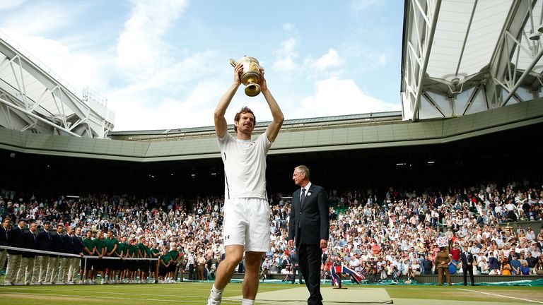 Andy Murray lifts the trophy following victory in the Men's Singles Final against Milos Raonic