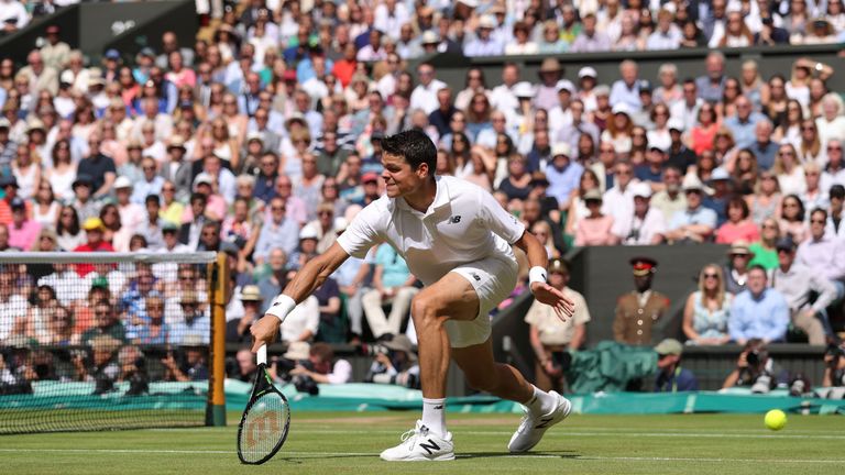 Milos Raonic returns to Andy Murray during the men's singles final match at Wimbledon