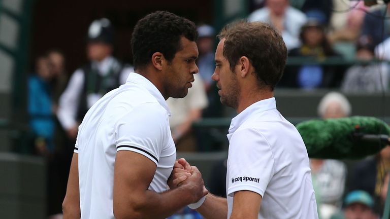 France's Jo-Wilfried Tsonga (L) shakes hands with France's Richard Gasquet (R) at the net