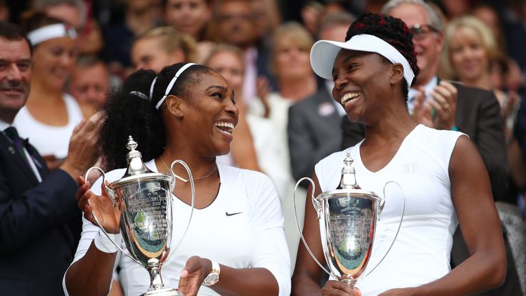 LONDON, ENGLAND - JULY 09:  Venus Williams of The United States and Serena Williams of The United States hold up their trophies following victory in the La