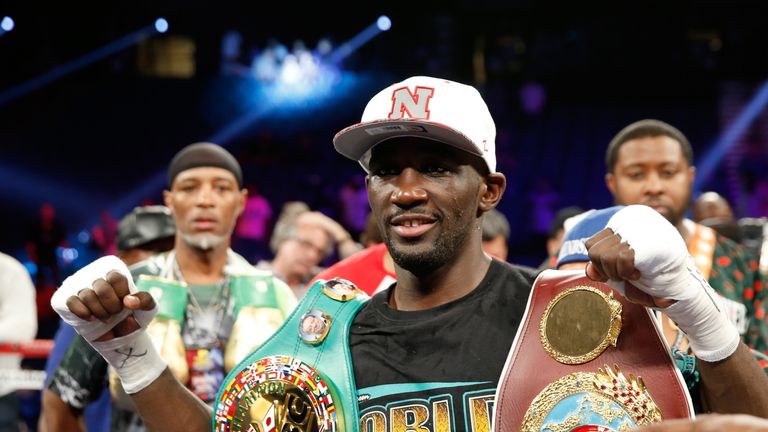 WBO junior welterweight champion Terence Crawford poses with belts after his unanimous decisionwin over WBC champion Viktor  Postol