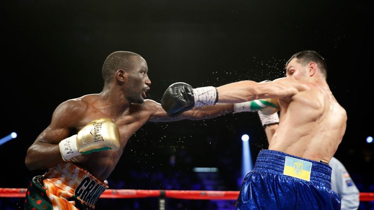 WBO junior welterweight champion Terence Crawford (L) punches WBC champion Viktor Postol of Ukraine during their unification figh