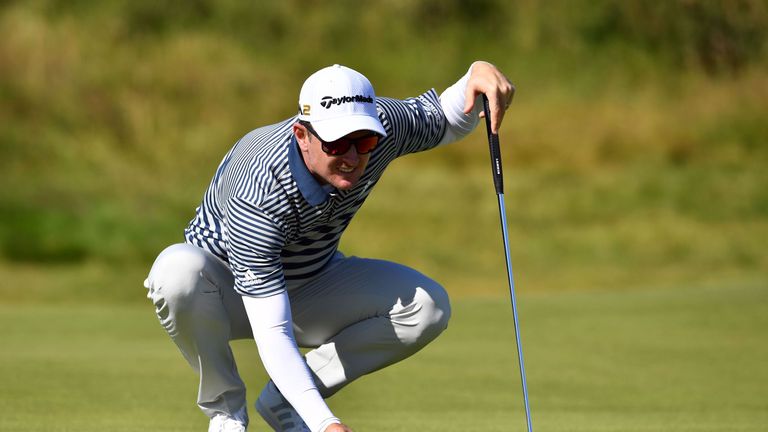 England's Justin Rose lines up a putt on the 4th Green during his first round on the opening day of the 2016 Open Golf Championship at Royal Troon