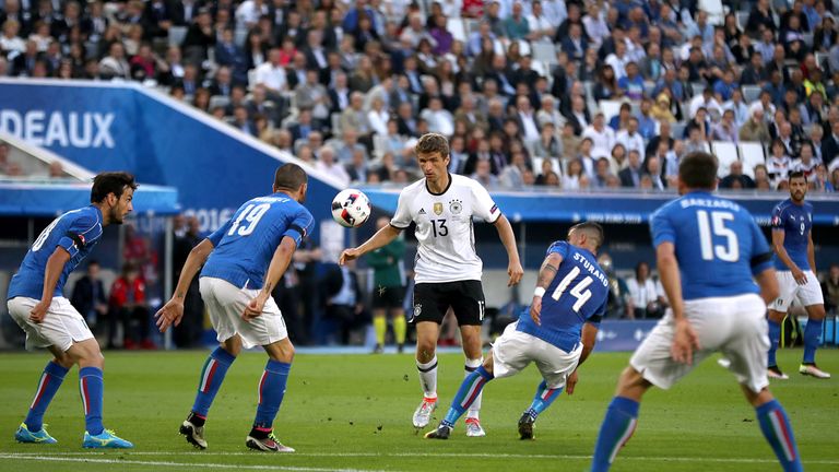 Germany's Thomas Muller (centre) battles for the ball with Italy's Stefano Sturaro (centre right)