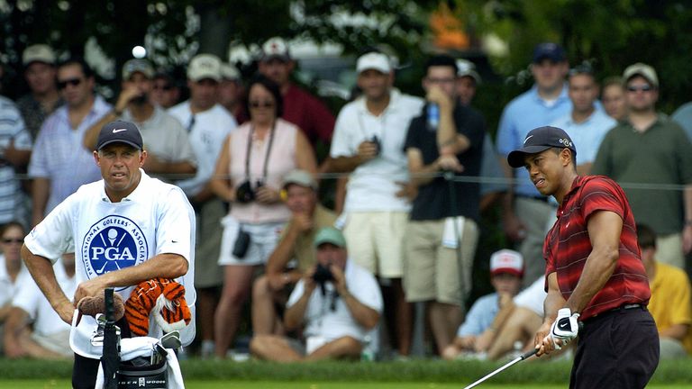 Springfield, UNITED STATES:  Tiger Woods (R) of the US chips on the green at the 1st hole as his caddie Steve Williams watches during the final round of th