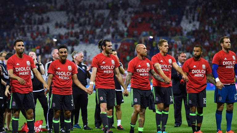 Wales players and staff applaud their supporters after defeat by Portugal