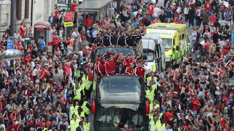 Fans cheer as they line Westgate Street to welcome the Wales team home