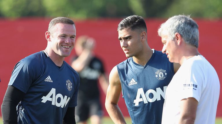 Wayne Rooney enjoys a joke with Jose Mourinho during a training session in Shanghai