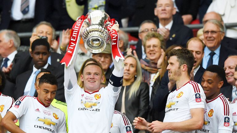 Manchester United skipper Wayne Rooney holds the FA Cup aloft in May