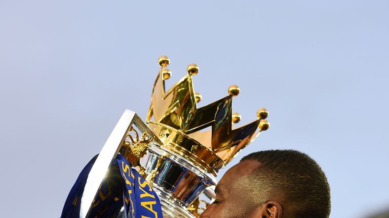 LEICESTER, ENGLAND - MAY 07:  Wes Morgan of Leicester City kisses the Premier League Trophy as players and staffs celebrate the season champions after the 