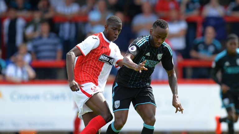 KIDDERMINSTER, ENGLAND - JULY 16:  Saido Berahino of  West Bromwich Albion is tackled by Ousmane Fane of Kidderminster Harriers during the Pre-Season Frien