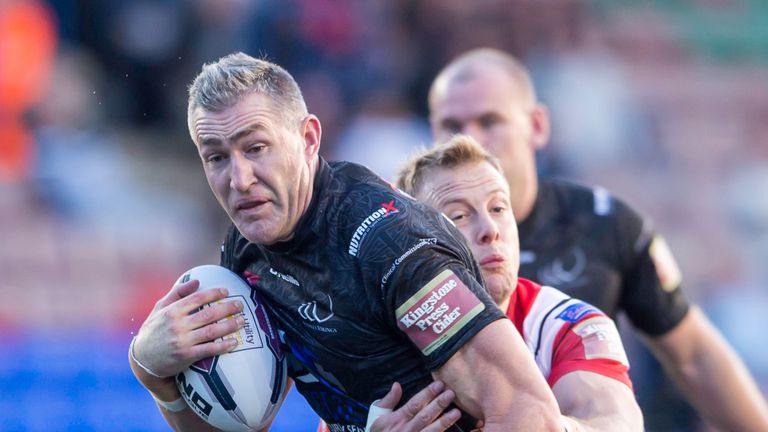Widnes's Chris Houston is tackled by Salford's Craig Kopczak.