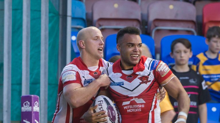 Salford's Mason Caton-Brown is congratulated by Craig Kopczak on scoring his second try against Widnes.
